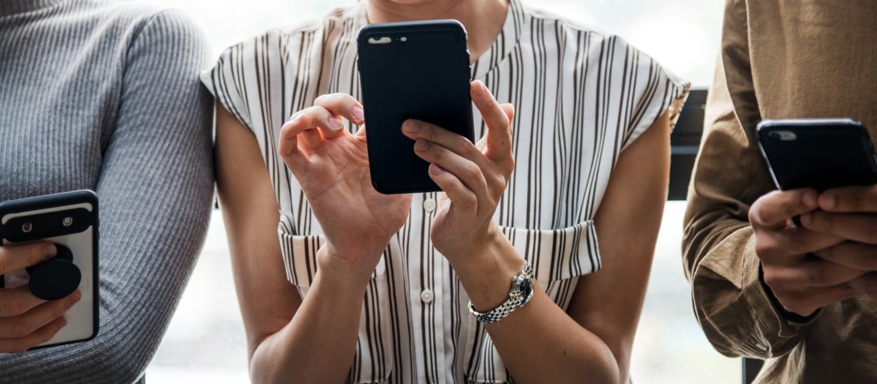 group of diverse people using smartphones