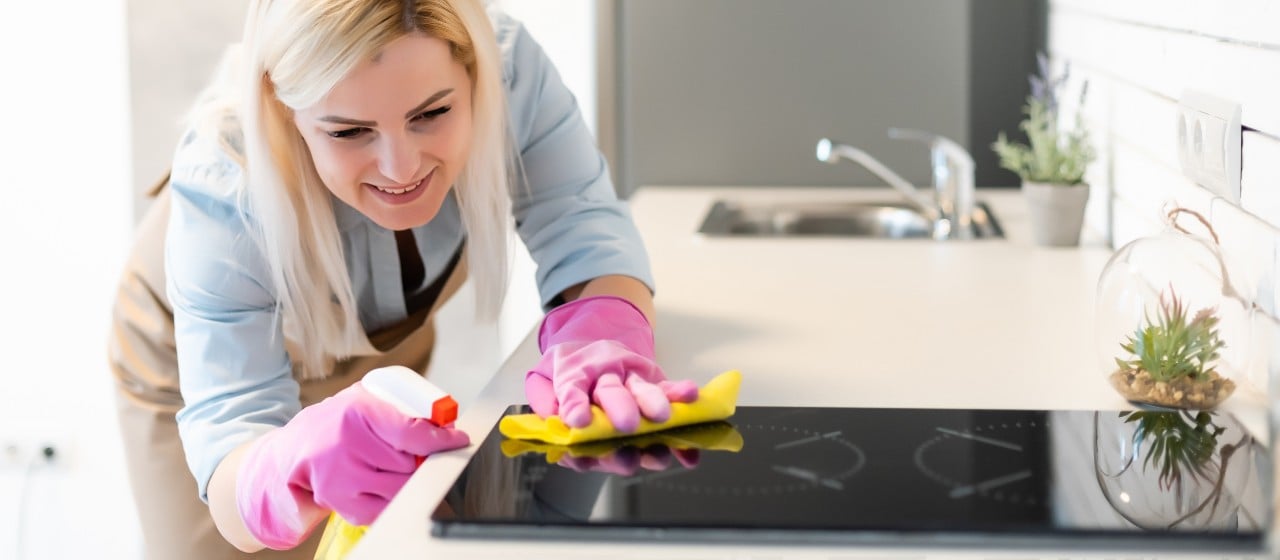 young woman doing housework cleaning the kitchen